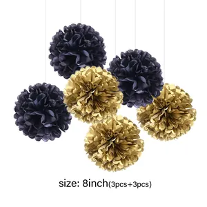 Detail of 8-inch gold and black tissue paper pom poms for birthday party decoration