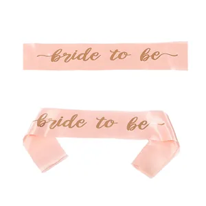 Detail of rose gold bride to be satin sash with gold foil lettering for bridal party