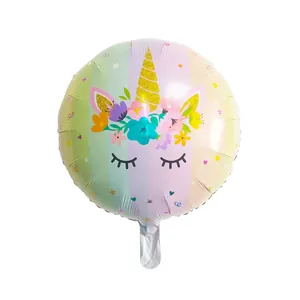 Close-up of unicorn foil balloon with glitter horn and macaron rainbow stripes