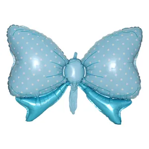 Macro detail of sky blue bow foil balloon with white polka dots for party decoration