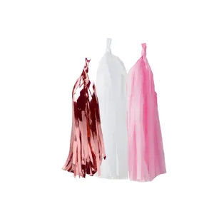 Detailed view of rose gold, pink, and white fringe tassels for bridal party decoration
