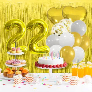 Golden number 22 foil balloons set with latex balloons and tinsel fringe backdrop
