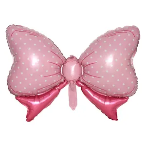 Pink bow foil balloon with white polka dots for birthday party and wedding decorations