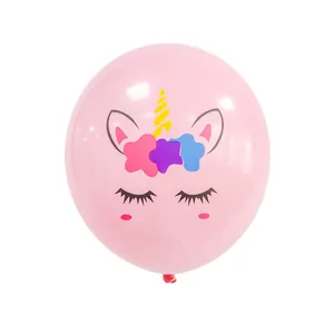Close-up of pink latex unicorn balloon with gold horn and floral print detail