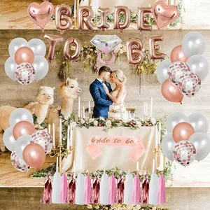 Rose gold Bride To Be party decor set with balloons, tassels, and a pink sash