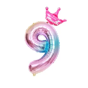 Macro detail of gradient number 9 foil balloon with pink crown for birthday party decor