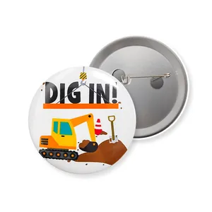 Detailed view of tinplate pin buttons with cartoon excavator design and safety pin back