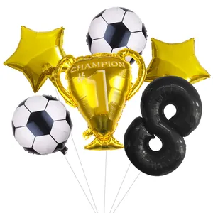 Detail of football party kit featuring champion trophy and golden star foil balloons