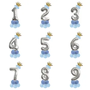 Silver foil number balloons from 1 to 9 with gold crowns and blue latex bases for birthdays