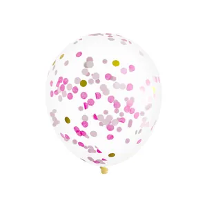 Close-up of clear latex balloon filled with festive pink and gold circular confetti