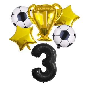 Detail of 3rd birthday soccer party set with golden trophy and star foil balloons