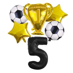 Detail view of soccer trophy and star foil balloons for 5th birthday party decoration