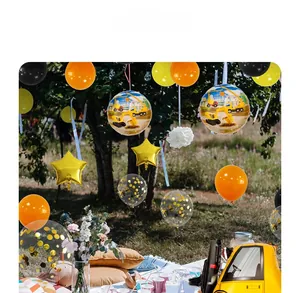 Construction party balloons with excavator foil and star shapes hung in a sunny garden