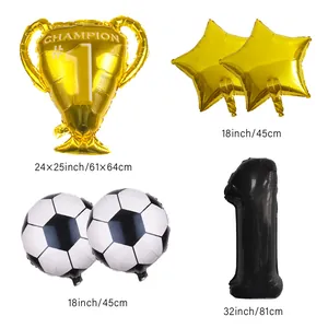Detail of football party kit with golden trophy, star balloons and number one foil balloon