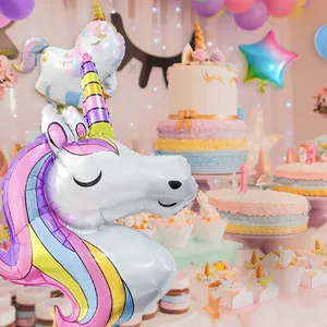 Macro shot of 3D unicorn foil balloon with rainbow gradient and golden horn for birthday decor