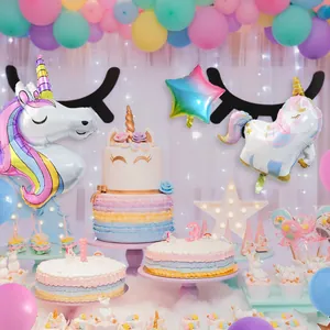 Close-up of unicorn foil balloons and pastel stars for a girl birthday party setup