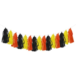 Close-up of black, orange, and yellow party fringe tassels hanging on a white string