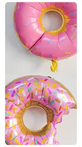 Close-up of pink doughnut foil balloons with colorful sprinkles and metallic texture