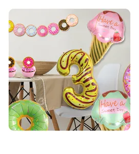 Detail of donut and ice cream foil balloons for 3rd birthday party setup
