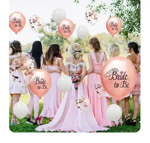 Detail of rose gold Bride to Be balloons and confetti sequins for wedding party decor