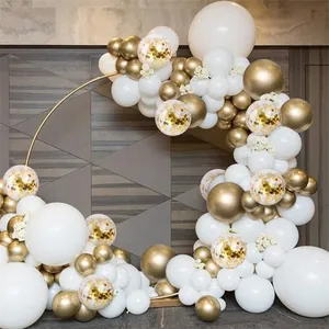 Elegant white and gold balloon arch kit with metallic balloons on a gold circular frame