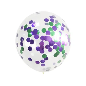 Detail of transparent latex balloon filled with purple and green circular confetti pieces