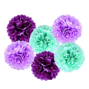 Detail view of 6-piece mermaid theme tissue paper pom-poms in purple and mint green colors