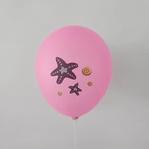 Pink mermaid party balloon with purple starfish and brown seashell prints on plastic stick