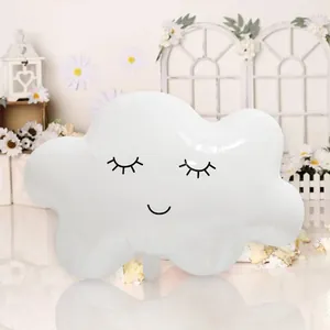 Close-up of white cloud foil balloon with cute smiley face for kids birthday party decor
