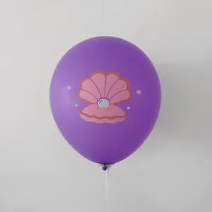 Detail of a purple latex mermaid balloon with pink pearl shell print on a plastic stick