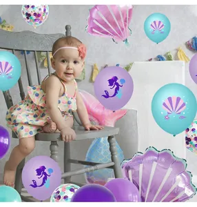 Detail of mermaid party balloons featuring shell and fishtail shapes in purple and blue