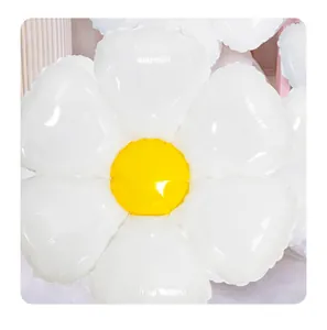 Close-up of a white daisy foil balloon with a yellow center for party decoration