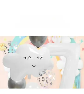 Close-up of white smiling cloud and large number 7 foil balloons for birthday party decor