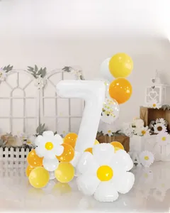 Daisy themed birthday party set with a large white number 7 and floral balloons