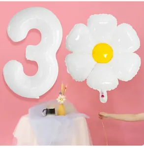 Detailed view of white number 3 balloon and daisy foil balloon for party decorations