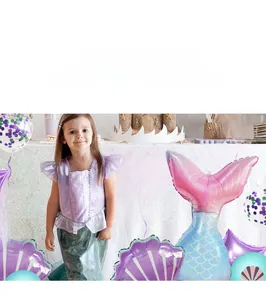 Mermaid party decoration set with seashell balloons and little girl in costume