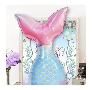Detail showing gradient mermaid tail foil balloon with gold scales and metallic luster