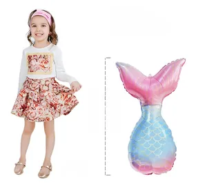 78cm mermaid tail foil balloon with pink blue gradient scales shown next to a 129cm child