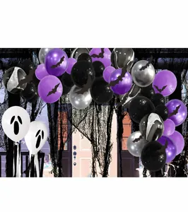 Detail view of Halloween balloon arch with purple, black, and ghost-faced balloons