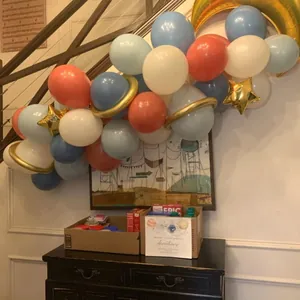 Detail of pink and blue balloon arch with gold star and crescent moon planet accents