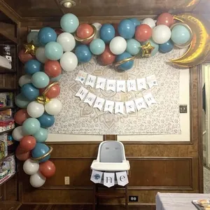 Gender reveal party decor with retro blue pink balloon arch and gold star moon foil balloons