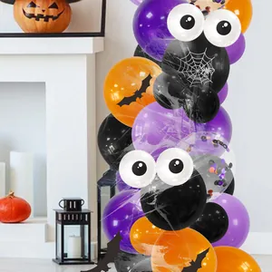 Halloween balloon arch detail with spider web prints and 3D eye elements