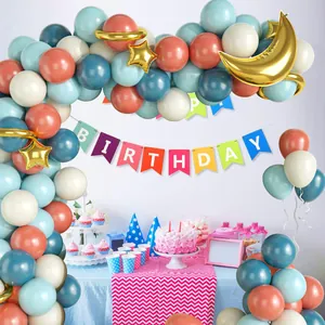 Retro gender reveal party decor with vintage blue pink balloons and gold stars