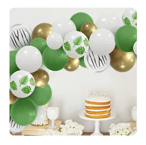 Close-up of jungle theme balloon arch with palm leaves, zebra prints, and gold latex balloons