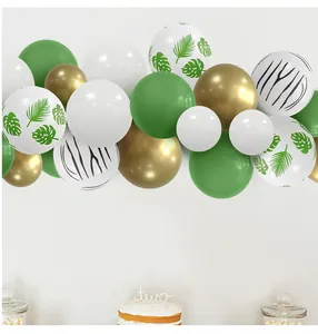 Detail of tropical balloon garland with gold accents and leaves for a 2nd birthday party