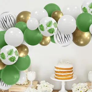 Jungle theme balloon arch kit with green white gold latex balloons and tropical leaves