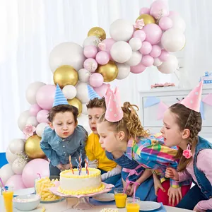 Macaron pink, white, and gold balloon arch kit with floral accents for party decoration