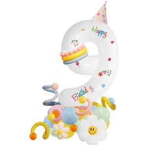 Detail of number 9 birthday balloon stand with daisy and macaron party decorations