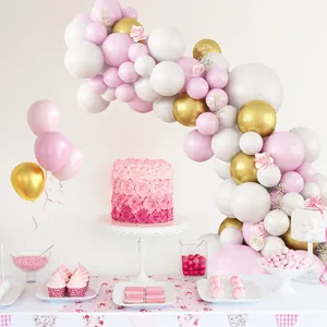 Pink and white macaron balloon arch kit with gold accents and floral decor for parties
