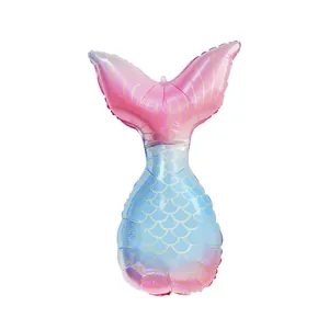 Detail of mermaid tail foil balloon with pink blue gradient and gold scale pattern